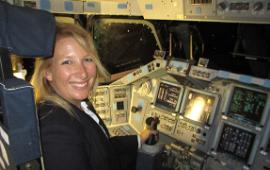 kim ellis sitting in Captain's chair of the space shuttle Endeavour in 2012
