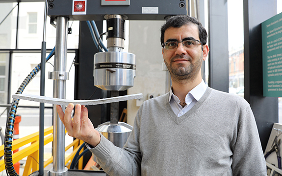 Dr Behzad Nematollahi with a piece of novel concrete produced from industrial waste products.