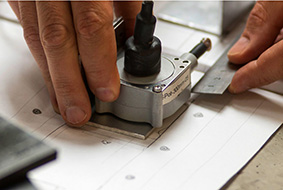 Draftsperson working on engineering plans