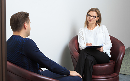 A female therapist talking to a male client