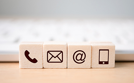 Wooden blocks with contact method icons printed on them