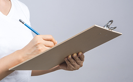 A lady holding a clipboard