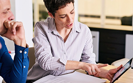 Business people looking at a tablet. 